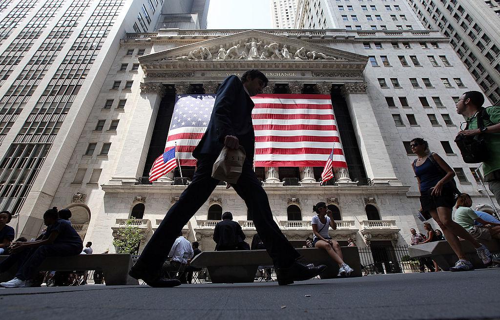 People walk past the New York Stock Exchange during afternoon trading in New York City on Aug. 4, 2011. (Mario Tama/Getty Images)