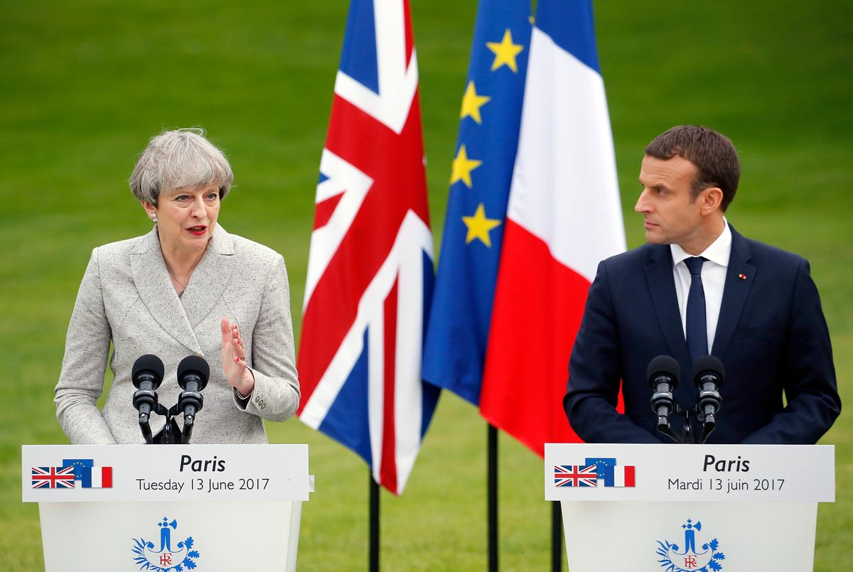 British Prime Minister Theresa May gives a joint press conference with French President Emmanuel Macron in Paris on June 13. May's negotiating position for Brexit has weakened following the elections. (Thierry Chesnot/Getty Images)