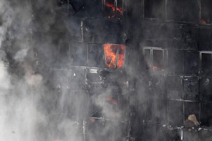 Flames continue to burn after a huge fire engulfed the 24 storey residential Grenfell Tower block in Latimer Road, West London in the early hours of this morning on June 14, 2017 in London, England. The Mayor of London, Sadiq Khan, has declared the fire a major incident as more than 200 firefighters are still tackling the blaze while at least 50 people are receiving hospital treatment. (Leon Neal/Getty Images)
