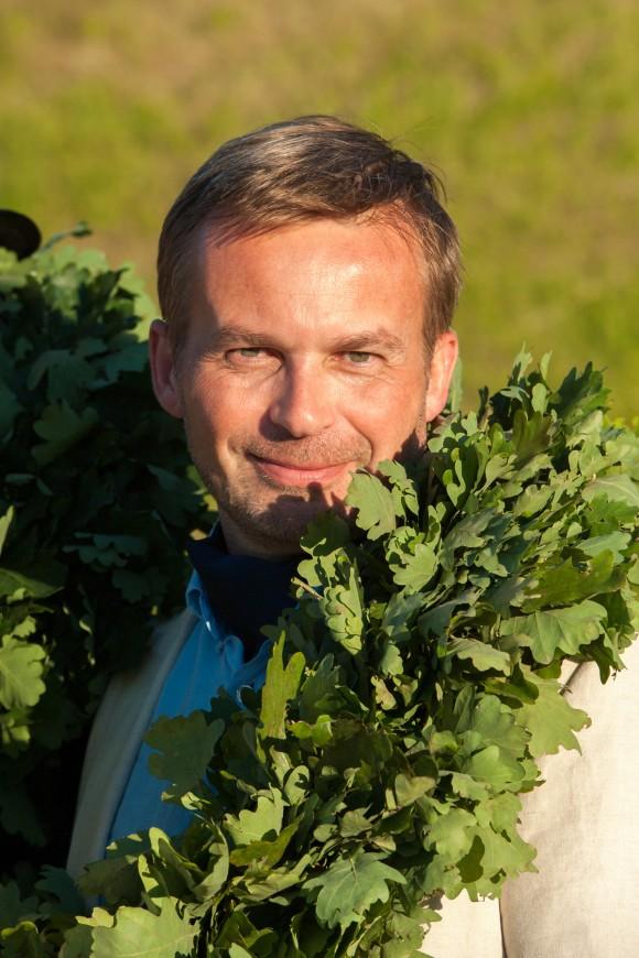 Sten Weidebaum, with a wreath of oak leaves traditionally given to organizers of the song and dance celebrations. Weidebaum was a participant in the Singing Revolution in the late '80s and now the communication manager of the Estonian Song and Dance Celebration Foundation. (Jaanus Ree)