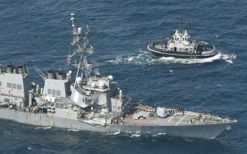 The Arleigh Burke-class guided-missile destroyer USS Fitzgerald, damaged by colliding with a Philippine-flagged merchant vessel, is seen next to a tugboat (R) off Shimoda, Japan in this photo taken by Kyodo June 17, 2017. (Mandatory credit Kyodo/via REUTERS)