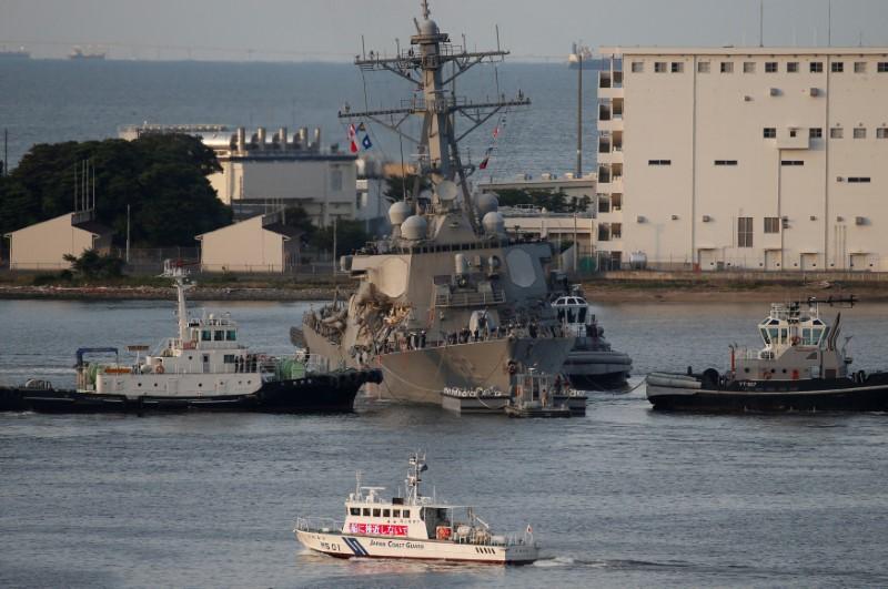 The Arleigh Burke-class guided-missile destroyer USS Fitzgerald, damaged by colliding with a Philippine-flagged merchant vessel, is towed by tugboats upon its arrival at the U.S. naval base in Yokosuka, south of Tokyo, Japan June 17, 2017. (REUTERS/Toru Hanai)