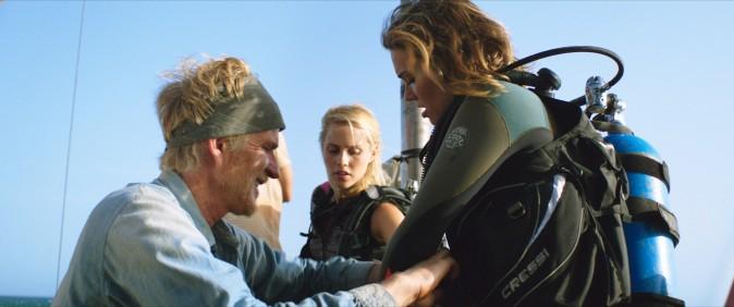 (L–R) Kate (Claire Holt) and Lisa (Mandy Moore) suit-up with the help of Captain Taylor (Matthew Modine) for an unforgettable underwater shark dive in "47 Meters Down." (Entertainment Studios Motion Pictures)