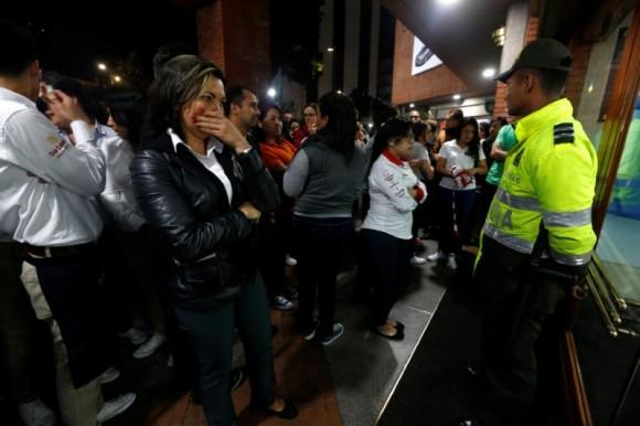 People stand outside the Andino shopping center after an explosive device detonated in a restroom, in Bogota, Colombia June 17, 2017. (Reuters/Jaime Saldarriaga)