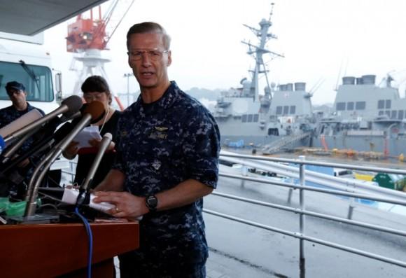 Vice Admiral Joseph Aucoin, U.S. 7th Fleet Commander, speaks to media on the status of the U.S. Navy destroyer USS Fitzgerald (seen behind him), damaged by colliding with a Philippine-flagged merchant vessel, and the seven missing Fitzgerald crew members, at the U.S. naval base in Yokosuka, south of Tokyo, Japan June 18, 2017. (Reuters/Toru Hanai)