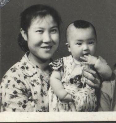 Jennifer's mother holding one-year-old Jennifer. In the same year this photo was taken, Jennifer's father was publicly denounced as a "black pawn of reactionary capitalist-roaders" during the "Great Proletarian Cultural Revolution," and Jennifer's mother had to tie Jennifer to her back and go out to post the "self-criticism" letters of Jennifer's father, as required. (Provided by Jennifer Zeng)