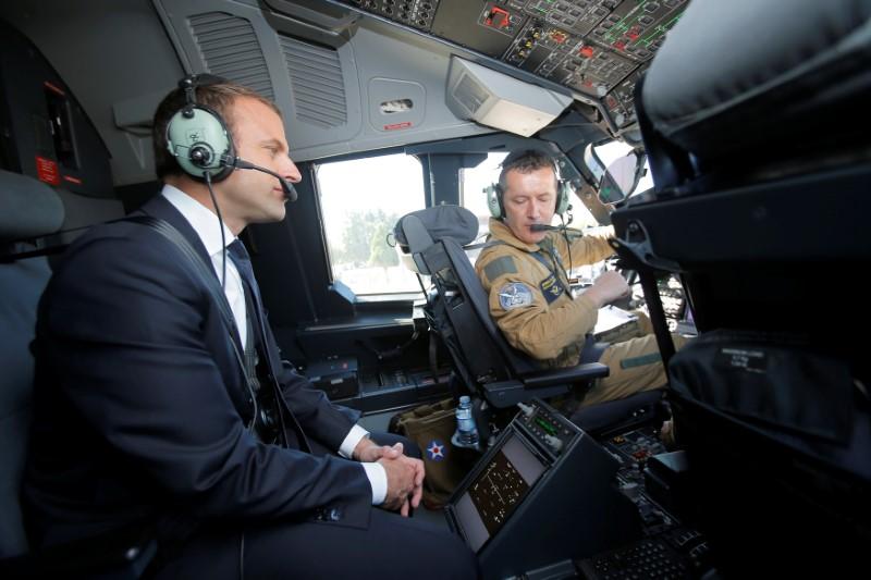 French President Emmanuel Macron sits in the cockpit of an Airbus A400M turboprop transport plane before taking off from Villacoublay military airbase near Paris, France, June 19, 2017. ()REUTERS/Michel Euler/Pool)