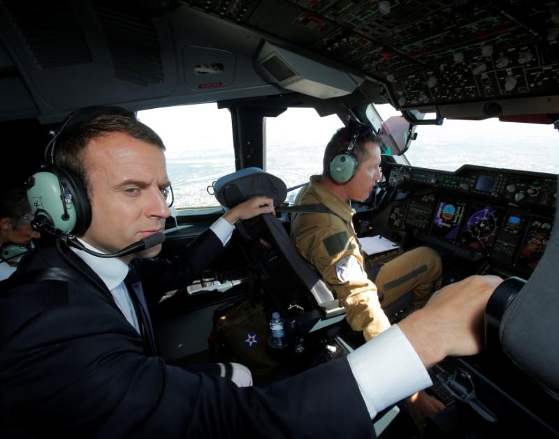 French President Emmanuel Macron sits in the cockpit of an Airbus A400M turboprop transport plane before taking off from Villacoublay military airbase near Paris, France on June 19, 2017. (REUTERS/Michel Euler/Pool)