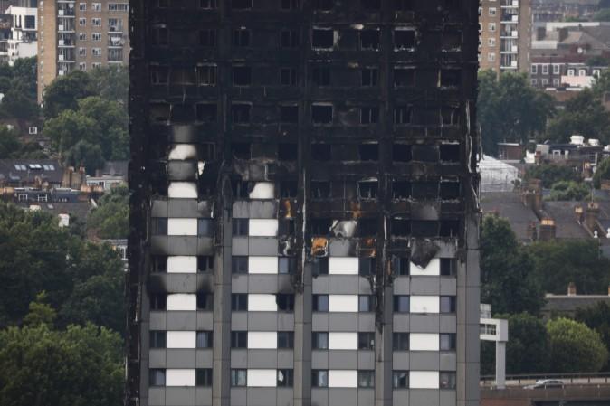 Unburned lower floors with untouched cladding in place are seen with the burnt out upper floors of the Grenfell Tower block in North Kensington, west London, on June 18, 2017. (Tolga Akmen/AFP/Getty Images)