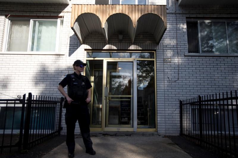 A police officer stands outside the home of Amor Ftouhi, in Montreal, Quebec, Canada on June 21, 2017. (REUTERS/Christinne Muschi)
