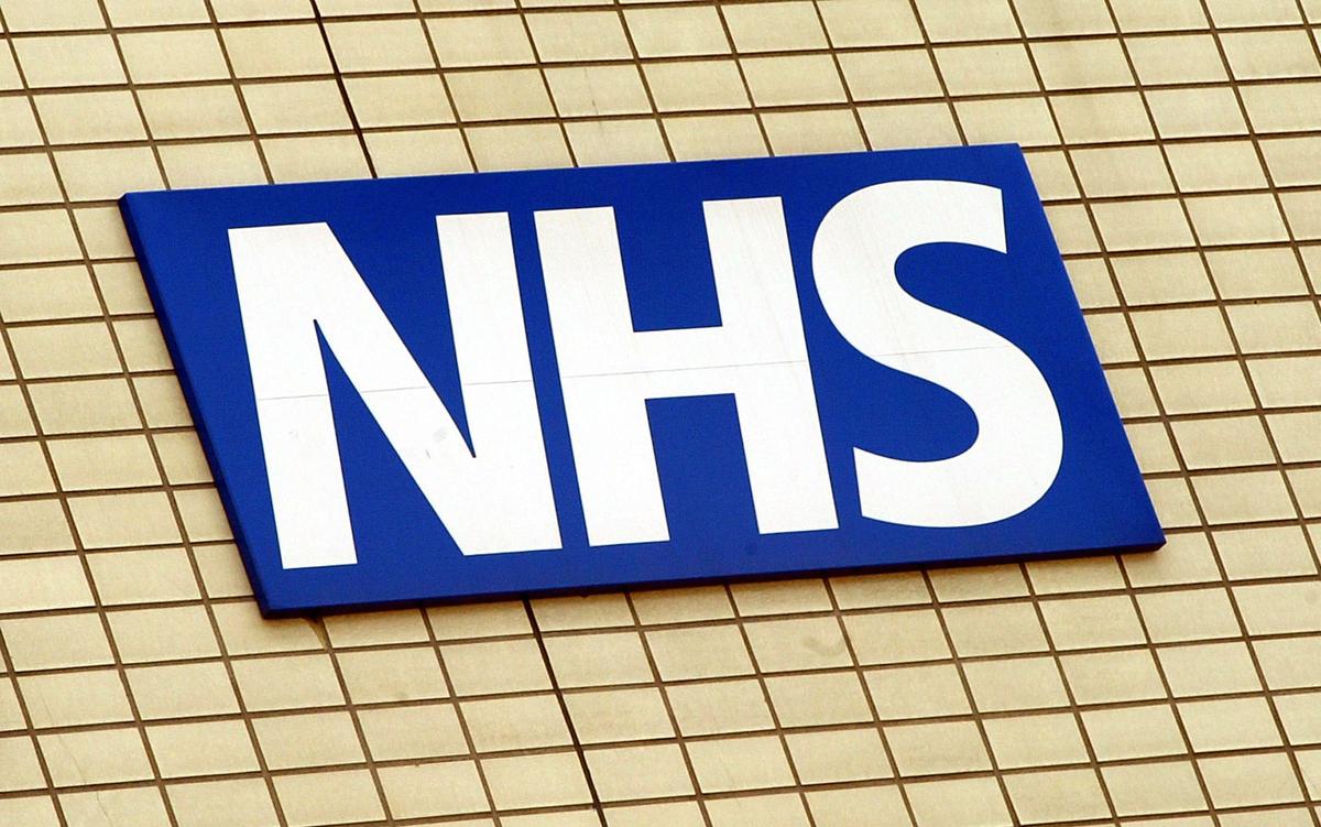 The National Health Service logo is shown on the wall outside St Thomas's Hospital in London, England May 7, 2003. (Scott Barbour/Getty Images)