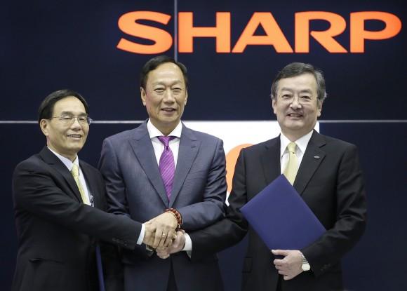 Chairman of Taiwan's Hon Hai Precision, also known as Foxconn, Terry Guo (C) and Vice Chairman Tai Jeng-wu (L) pose with President of Japan's Sharp Kozo Takahashi (R) during a press conference in Osaka, western Japan, on April 2, 2016. Sharp agreed to be bought by Taiwanese multinational Hon Hai Precision, the world's biggest electronics supplier. (STR/AFP/Getty Images)