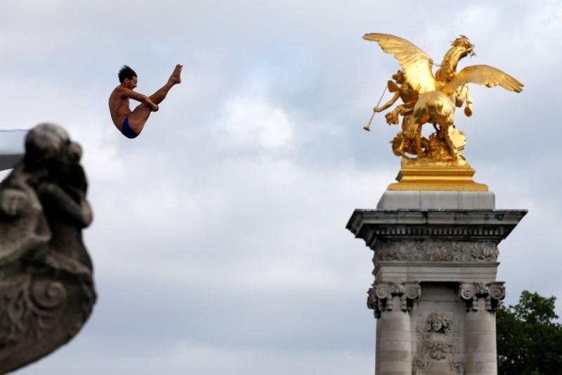 A diver performs from the Pont Alexandre III bridge into the River Seine in Paris, France, June 23, 2017. REUTERS/Jean-Paul Pelissier TPX IMAGES OF THE DAY