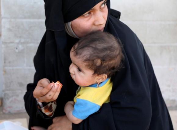 A woman feeds her baby after fleeing Mosul's Old City, the last district in the hands of Islamic State militants, during fighting between Iraqi forces and Islamic State militants in western Mosul, Iraq June 24, 2017. (Reuters/Marius Bosch)