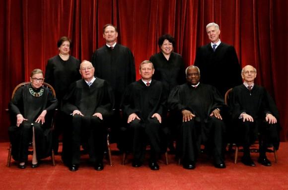 Chief Justice John Roberts (seated C) leads Justice Ruth Bader Ginsburg (front row, L-R), Justice Anthony Kennedy, Justice Clarence Thomas, Justice Stephen Breyer, Justice Elena Kagan (back row, L-R), Justice Samuel Alito, Justice Sonia Sotomayor, and Associate Justice Neil Gorsuch in taking a new family photo including Gorsuch, their most recent addition, at the Supreme Court building in Washington on June 1, 2017. (REUTERS/Jonathan Ernst)