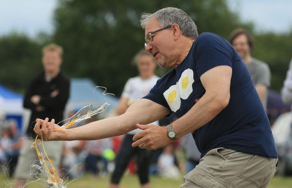 A competitor fails to catch a thrown egg without it smashing during an egg throwing discipline of the 2017 World Egg Throwing Championships at Swaton Vintage Fair in Lincolnshire, England on June 25, 2017.<br/>(LINDSEY PARNABY/AFP/Getty Images)