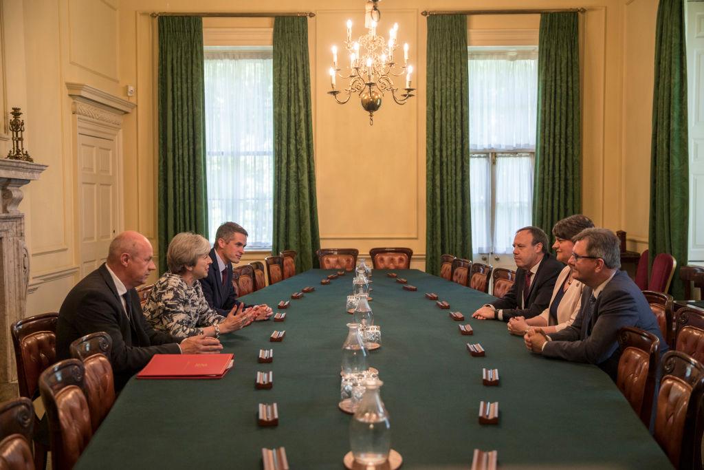 Prime Minister Theresa May (2L) sits with First Secretary of State Damian Green (L), and Parliamentary Secretary to the Treasury, and Chief Whip, Gavin Williamson (3L) as they talk with Democratic Unionist Party (DUP) leader Arlene Foster (2R), DUP Deputy Leader Nigel Dodds (3R), and DUP MP Jeffrey Donaldson, inside 10 Downing Street in London, England on June 26, 2017. (Jack Hill - WPA Pool /Getty Images)