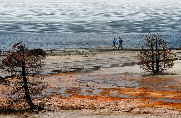 Tourists walk beside Yellowstone Lake at the West Thumb Geyser Basin in the Yellowstone National Park, Wyoming on June 2, 2011. (MARK RALSTON/AFP/Getty Images)