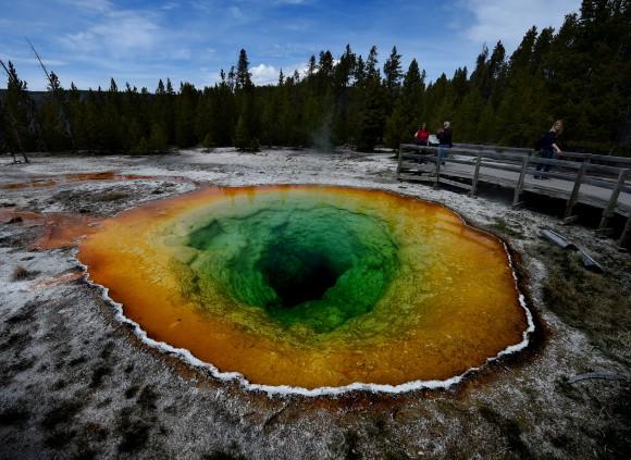 Tourists view the Morning Glory hot spring in the Upper Geyser Basin of Yellowstone National Park in Wyoming, on May 14, 2016. (Photo credit should read MARK RALSTON/AFP/Getty Images)