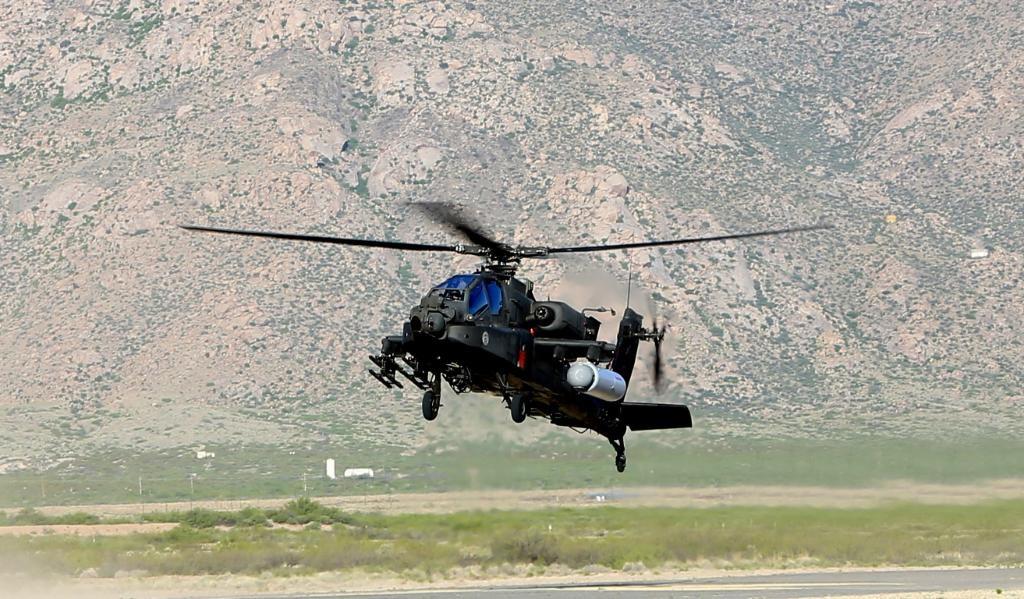 An Apache helicopter with a mounted laser weapon. (Raytheon)