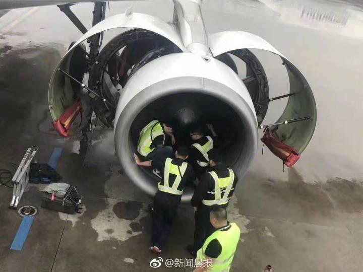 Aircraft maintenance staff inspect the engine of an Airbus A320 jet for coins.