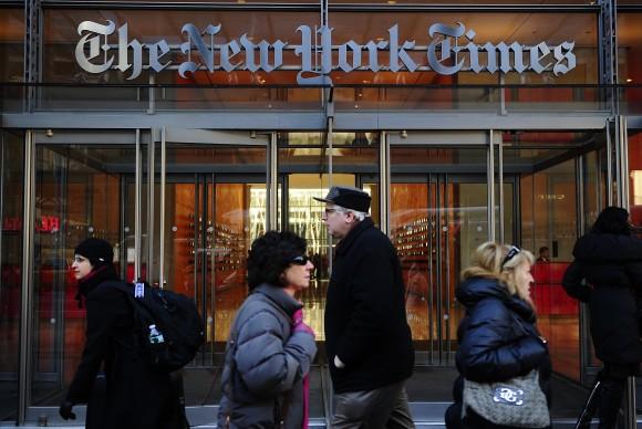 People walk by the entrance to US newspaper 'The New York Times' in New York, March 8, 2011. (EMMANUEL DUNAND/AFP/Getty Images)