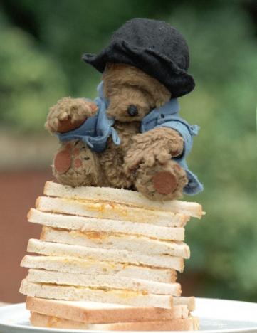 The original Paddington Bear which starred in dozens of BBC television programmes sits on a stack of marmelade sandwiches in London on April 29, 1997. (REUTERS/Dennis Owen)