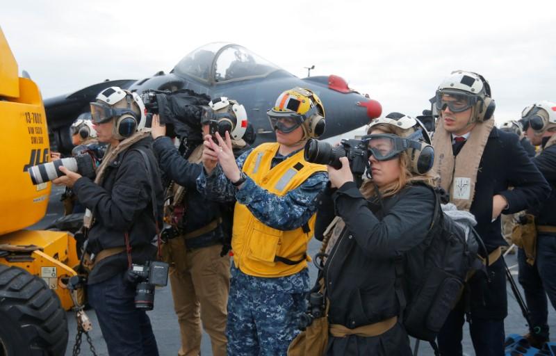 Journalists record activities aboard the USS Bonhomme Richard amphibious assault ship off the coast of Sydney, Australia, before a ceremony marking the start of Talisman Saber 2017, a biennial joint military exercise between the United States and Australia June 29, 2017. (REUTERS/Jason Reed)