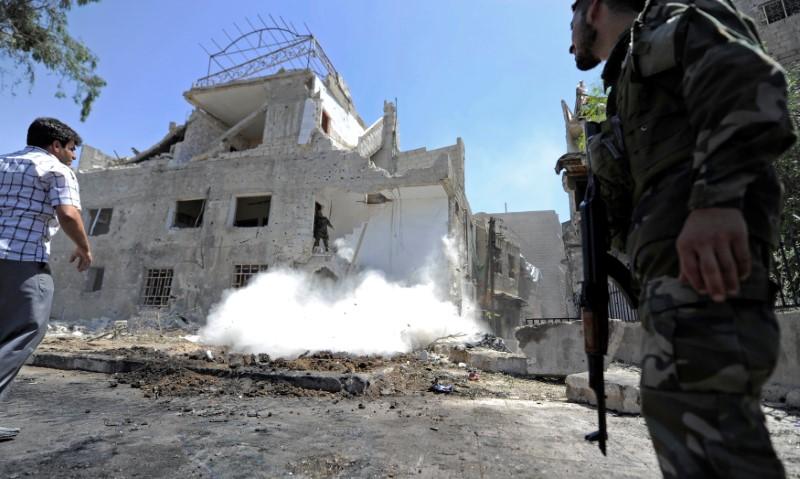 An army soldier secures the area of a blast site in the Baytara traffic circle near the Old City of Damascus, Syria July 2, 2017. (Reuters/Omar Sanadiki)