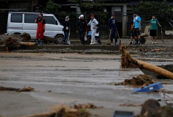 Local residents prepare to remove mud and debris which were swept by heavy rain in Asakura, Fukuoka Prefecture, Japan July 8, 2017. (Reuters/Issei Kato)