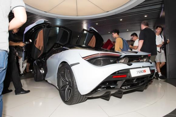 People from the media pour over the McLaren 720S at the Wanchai showroom for its Hong Kong launch on June 29, 2017. (Bill Cox/Epoch Times)