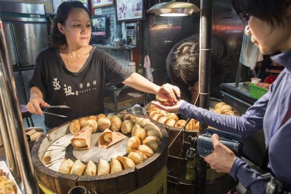 A vendor sells a popular pastry cake at Shilin Night Market. (Rayman Cheuk Wai-man/Shutterstock)