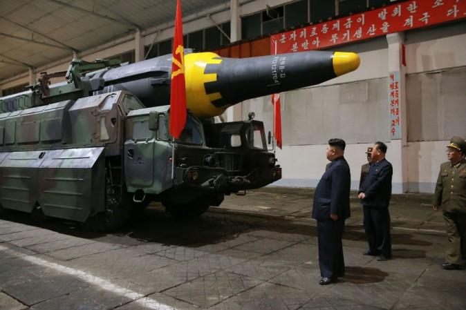 North Korean leader Kim Jong Un (L) inspects a Hwasong-12 strategic ballistic rocket at an undisclosed location. The photo was released by North Korean state media on May 15.<br/>(STR/AFP/Getty Images)
