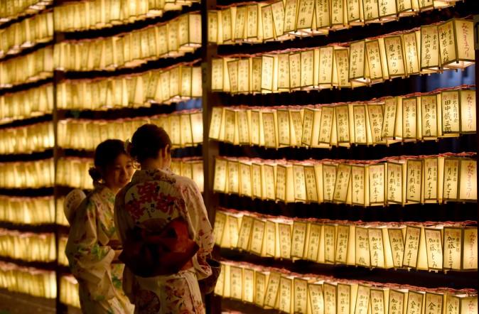 Women walk among rows of lit lanterns during the Mitama Matsuri festival at the Yasukuni Shrine in Tokyo on July 13, 2017. Some 30,000 lanterns were illuminated in the precinct in memory of the war victims. (TORU YAMANAKA/AFP/Getty Images)