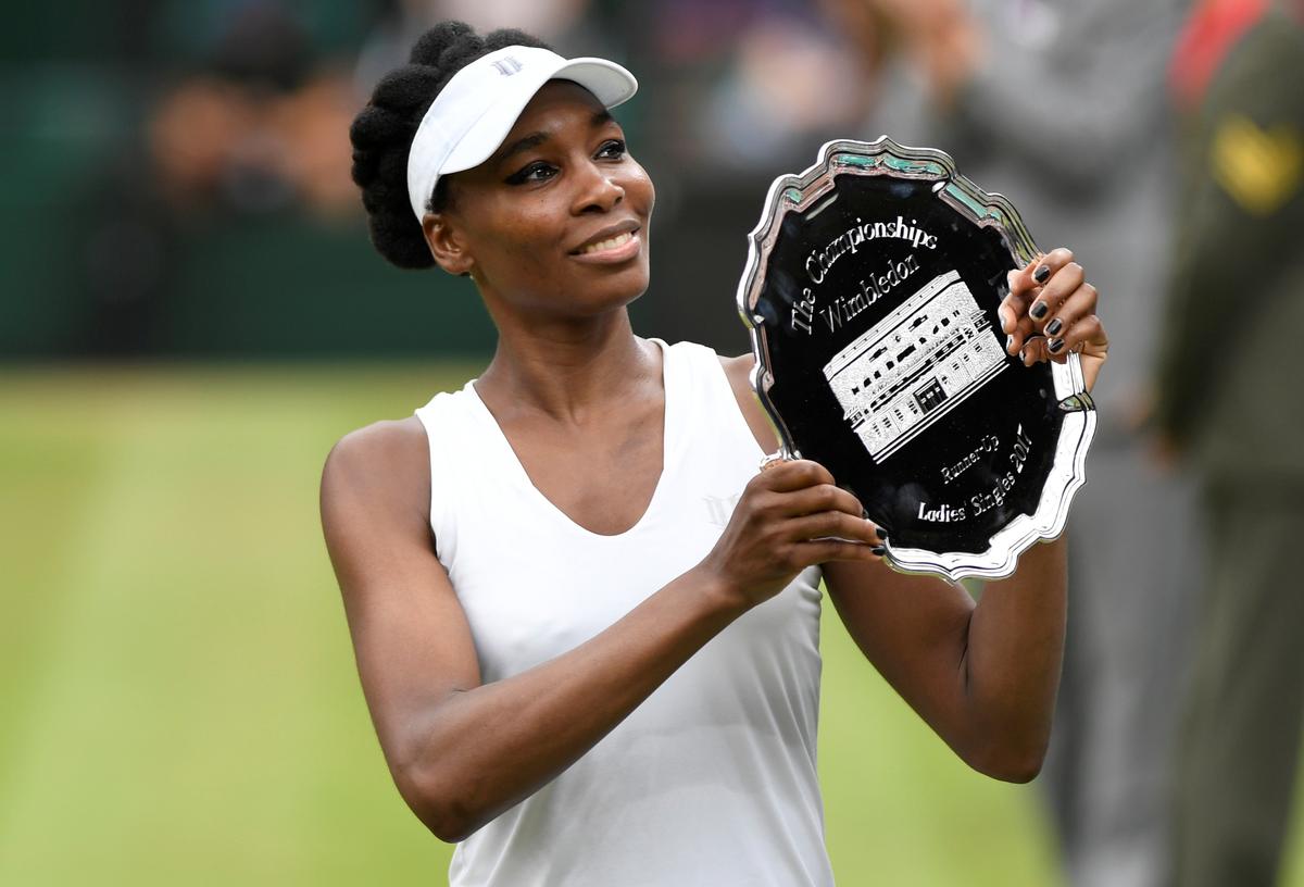 Tennis - Wimbledon - London, Britain - July 15, 2017 Venus Williams of the U.S. poses with the runner up trophy after losing the final against Spain's Garbine Muguruza REUTERS/Tony O'Brien