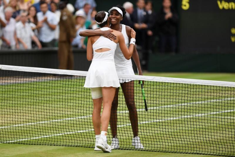 Tennis - Wimbledon - London, Britain - July 15, 2017 Spain's Garbine Muguruza with Venus Williams of the U.S. after winning their final match REUTERS/Tony O'Brien