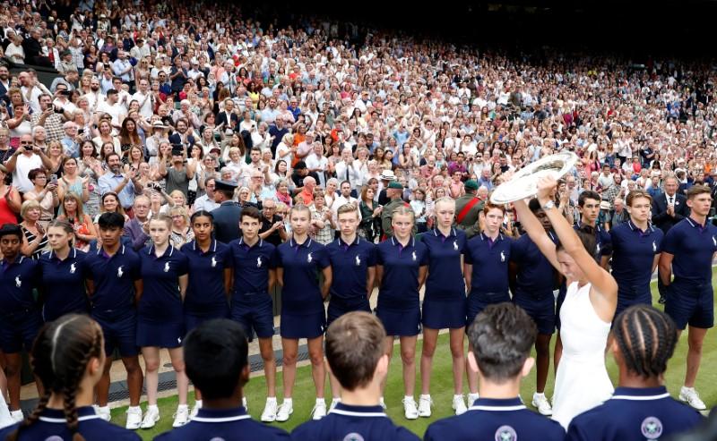 Tennis - Wimbledon - London, Britain - July 15, 2017 Spain's Garbine Muguruza poses with the trophy as she celebrates winning the final against Venus Williams of the U.S. REUTERS/Matthew Childs