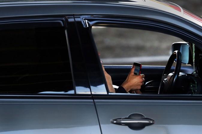 A driver uses a phone while behind the wheel of a car on in New York City. (file, Spencer Platt/Getty Images)