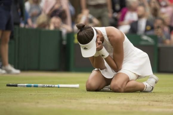 Garbine Muguruza celebrates match point during her women's finals match against Venus Williams on day twelve at the All England Lawn Tennis and Croquet Club in London, Jul 15, 2017. (Susan Mullane/USA Today Sports)