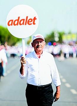 Kemal Kilicdaroglu, leader of Turkey's Republican People's Party (CHP), holds a placard that reads "justice" as he walks with thousands of supporters toward the Maltepe district of Istanbul on July 9. CHP, Turkey's main opposition party, came in second in the Jun 2015 general election, securing 132 seats in the 550-seat parliament. (GURCAN OZTURK/AFP/GETTY IMAGES)