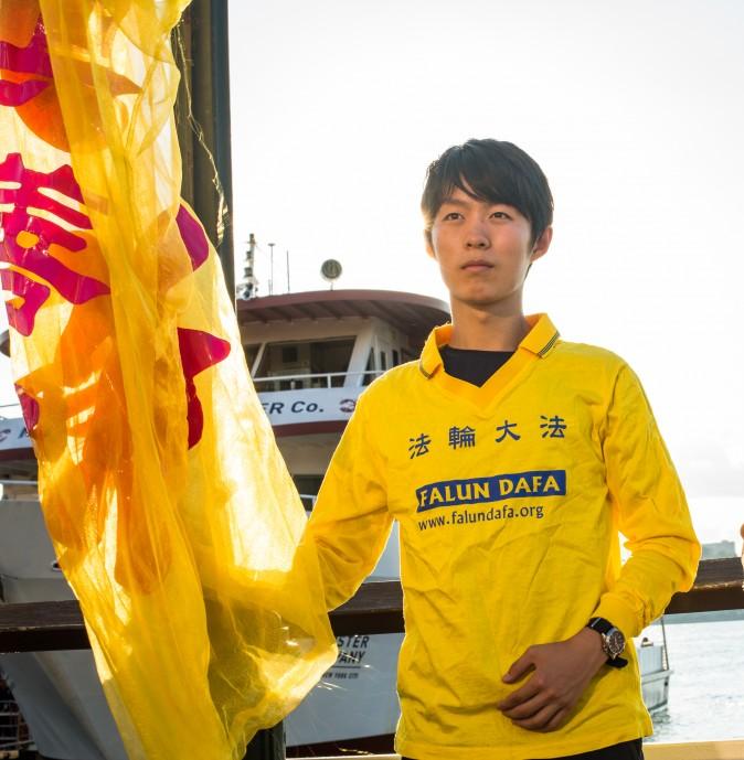 Collin Ding joins other Falun Gong practitioners for a rally and a candlelight vigil in front of the Chinese Consulate in New York on July 16, 2017. Ding said he was there to peacefully protest the continued persecution of his beliefs. (Benjamin Chasteen/The Epoch Times)