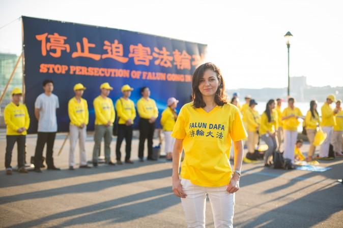 Cristina Oz joins Falun Gong practitioners in front of the Chinese Consulate in New York for a rally and candlelight vigil calling for an end to the persecution on July 16, 2017. (Benjamin Chasteen/The Epoch Times)