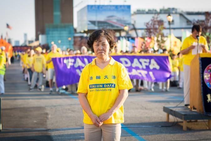 Li Dianqin joins other Falun Gong practitioners in front of the Chinese Consulate in New York for a rally and candlelight vigil calling for an end to the persecution on July 16, 2017. (Benjamin Chasteen/The Epoch Times)