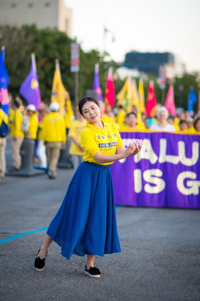 A woman performs a song and dance at a rally in front of Chinese Consulate in New York calling for an end to the Falun Gong persecution inside China in New York on July 16, 2017. (Benjamin Chasteen/The Epoch Times)