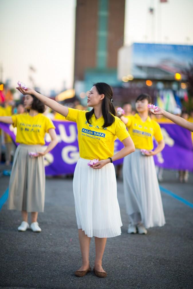 Women perform a song and dance at a rally in front of the Chinese Consulate in New York calling for an end to the Falun Gong persecution inside China in New York on July 16, 2017. (Benjamin Chasteen/The Epoch Times)