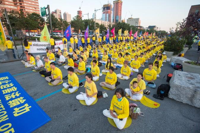 Hundreds of Falun Gong practitioners and supporters hold a candlelight vigil in front of the Chinese Consulate in New York on July 16, 2017. Launched on July 20, 1999, the persecution is now entering its 18th year inside China. (Benjamin Chasteen/The Epoch Times)