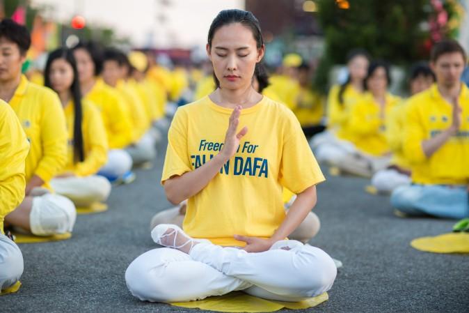 Hundreds of Falun Gong practitioners and supporters hold a candlelight vigil in front of the Chinese Consulate in New York on July 16, 2017. Launched on July 20, 1999, the persecution is now entering its 18th year inside China. (Benjamin Chasteen/The Epoch Times)