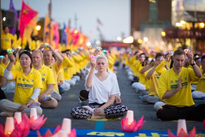 Hundreds of Falun Gong practitioners and supporters hold a candlelight vigil in front of the Chinese Consulate in New York on July 16, 2017. Launched on July 20, 1999, the persecution is now entering its 18th year inside China. (Benjamin Chasteen/The Epoch Times)