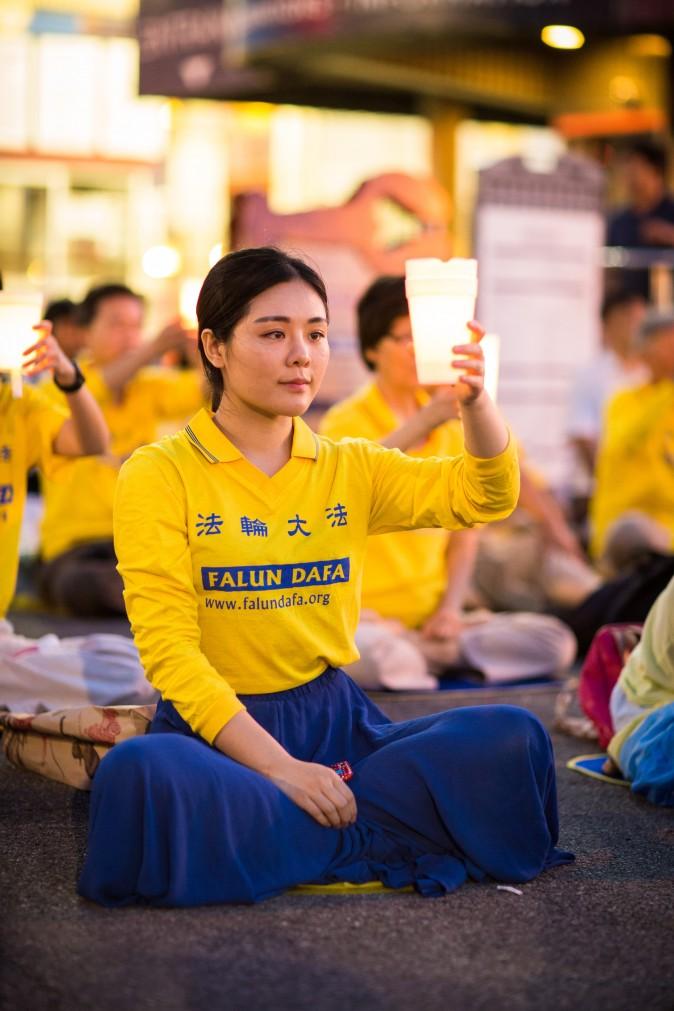 Hundreds of Falun Gong practitioners and supporters hold a candlelight vigil in front of the Chinese Consulate in New York on July 16, 2017. Launched on July 20, 1999, the persecution is now entering its 18th year inside China. (Benjamin Chasteen/The Epoch Times)