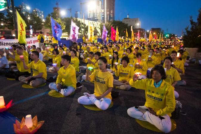 Hundreds of Falun Gong practitioners and supporters hold a candlelight vigil in front of the Chinese Consulate in New York on July 16, 2017. Launched on July 20, 1999, the persecution is now entering its 18th year inside China. (Benjamin Chasteen/The Epoch Times)